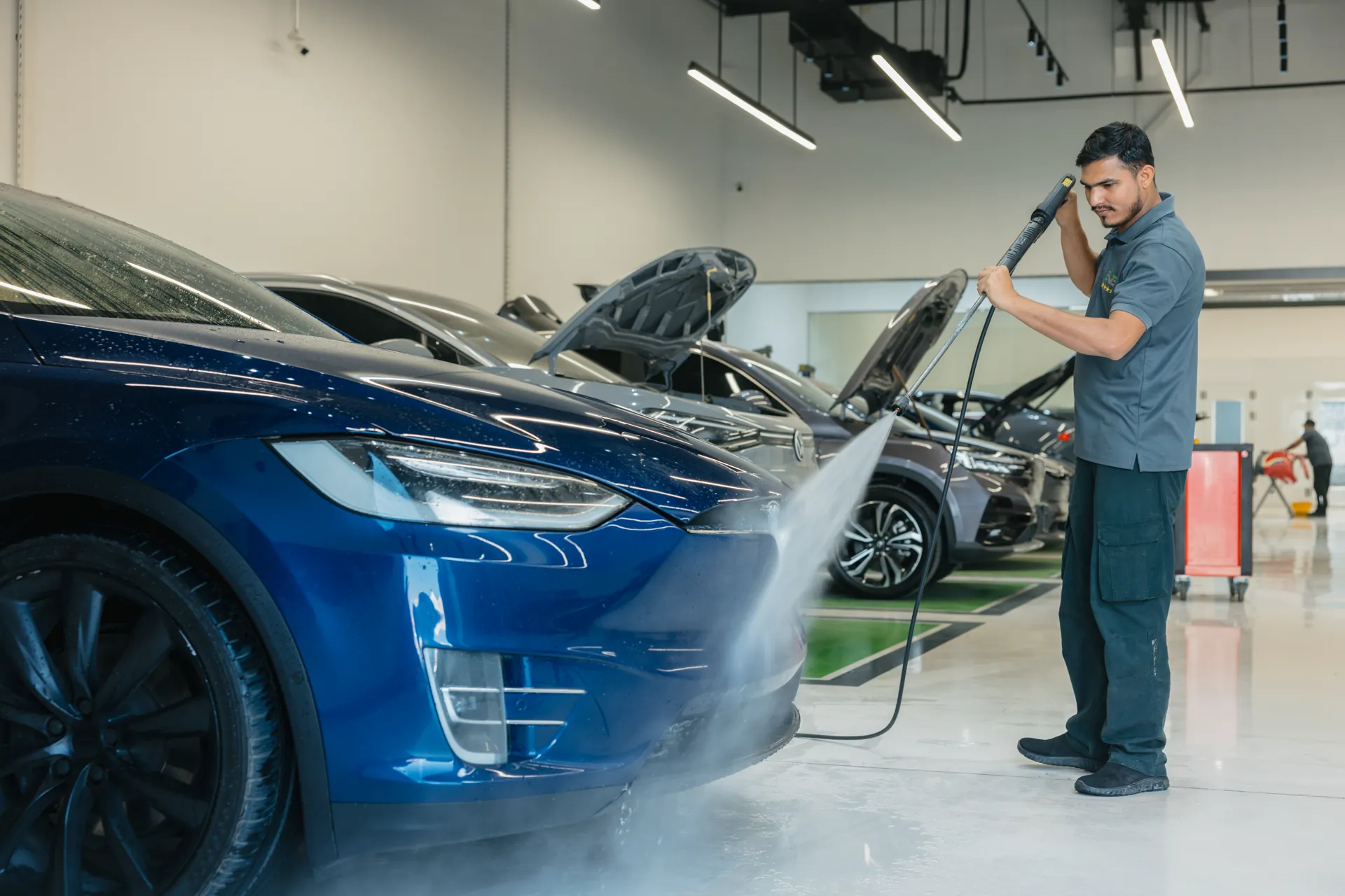 Electric vehicles across the bays of an EVS workshop floor