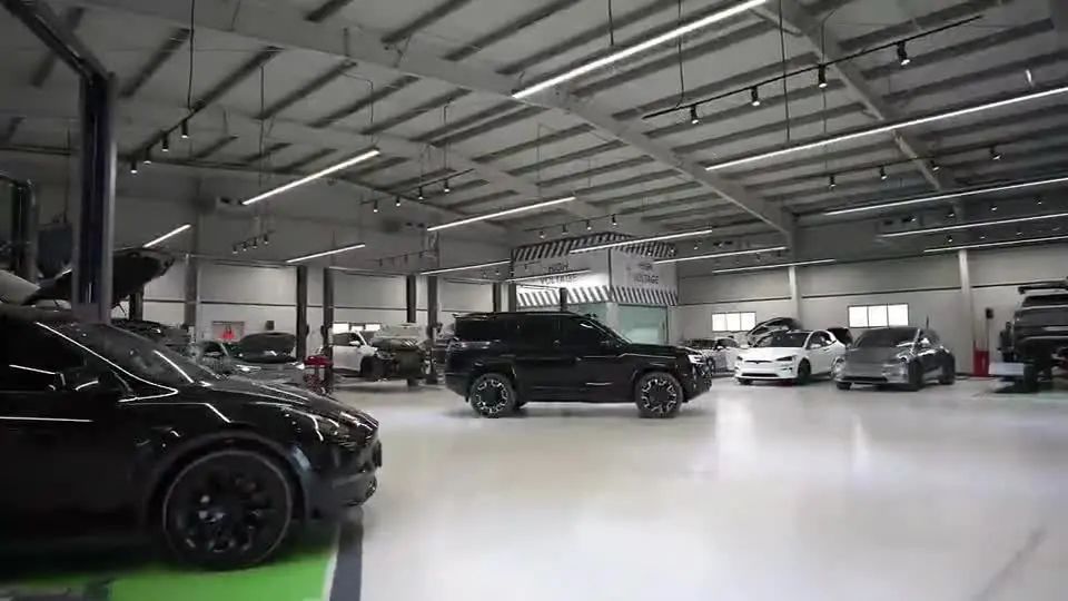 The EVS workshop floor with electric vehicles on the ramps